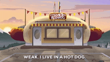 South Park gif. Shot of the Coney Island Hot Dog building that slowly zooms out to show the entirety of the hot dog. Text, "Weak. I live in a hot dog."