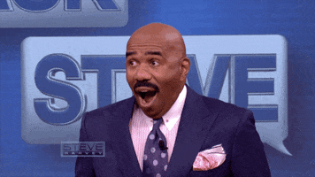 TV gif. Steve Harvey on his show looks shocked and then smiles really awkwardly in reaction to something. 