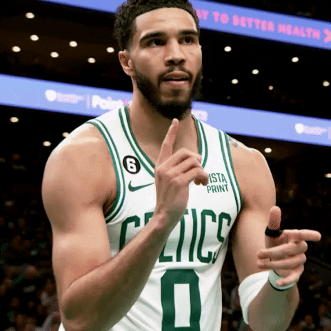 Sports gif. Slow motion video of Jayson Tatum of the Boston Celtics looking cool and confident, as he walks across the court holding up two finger guns and moving them up and down like he's firing shots.
