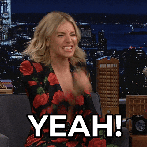 Celebrity gif. Sienna Miller in a late night interview smiles energetically and raises a fist. Text, "Yeah!"