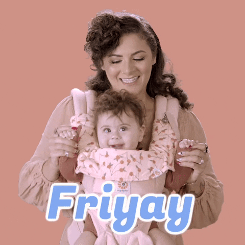 Video gif. A brunette woman wears a baby carrier cross her chest with a baby inside. Looking at us, she holds the baby's hands as she grins and bounces back and forth, glancing down at her baby with joy. Text, "Friyay"