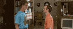 Movie gif. Napoleon Dynamite gives his brother Kip a lazy shove to the shoulder. At the same time, Kip gives Napoleon a wimpy slap to the head.