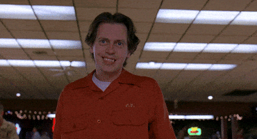 Movie gif. Steve Buscemi as Theodore in The Big Lebowski watches his bowling ball hit the pins and he excitedly reacts, shaking his body, and then happily walking back to his seat.