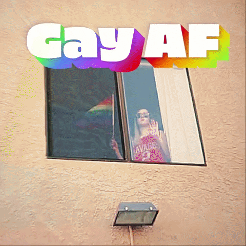 Video gif. A woman is seen in her window coolly waving a LGBTQIA flag. We zoom in in on her and she never breaks expression or stops waving the flag. Text, "Gay AF."