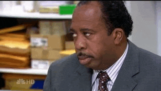 The Office gif. Leslie David Baker as Stanley, seated, rolls his eyes exaggeratedly. He is exasperated to no end.