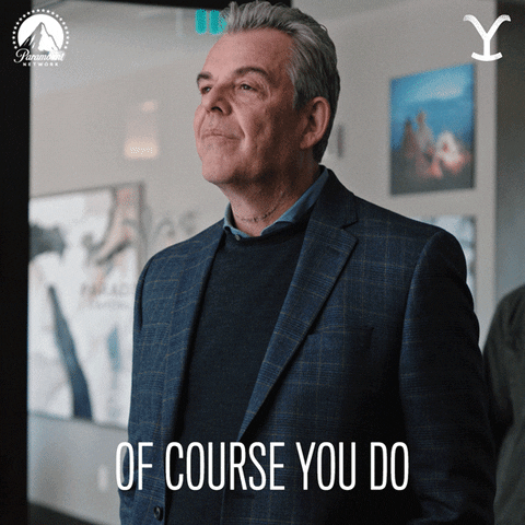 TV gif. Danny Huston as Dan in Yellowstone. He stands tall with his head lifted as he peers down and he gives a grim, unblinking smile as he says, "Of course you do."