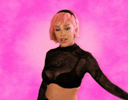 Celebrity gif. Doja Cat stands in front of a pink background, with pink hair, and sticks her tongue out, giving a thumbs up as she looks at us. She leaves, then replicates behind herself, in an endless loop of what we just saw.