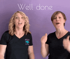 Video gif. Two women give us double thumbs up and grin at our accomplishment. Text, "Well done."