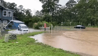Flooding Partially Submerges Car in South Carolina Neighborhood