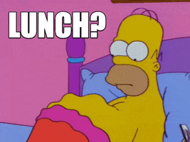 The Simpsons gif. Homer lays in bed staring down at his protruding belly as it jigglies in waves. Text, "Lunch?"
