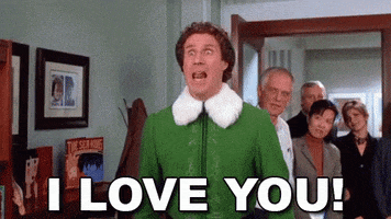 Movie gif. Will Ferrell in Elf. He's standing in a hallway with a crowd of people behind him as he yells at the top of his lungs, "I love you!" He says this three times, bouncing up and down in excitement and nervousness as he does.
