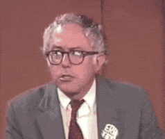 Political gif. A younger Bernie Sanders listens to us, and raises his eyebrows in a response that seems to say "I read you loud and clear."