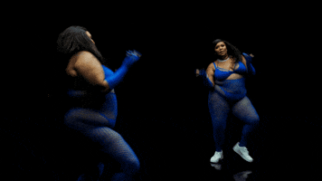 Celebrity gif. Lizzo is performing at the Savage x Fenty show and she's dancing by herself, tossing her arms out with charisma.