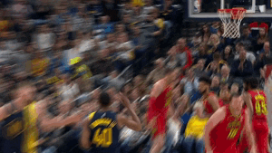 Sports gif. Pacers player Glenn Robinson III runs backwards on the court while Domantas Sabonis encouragingly gives him a head rub and an assuring tap on the butt.