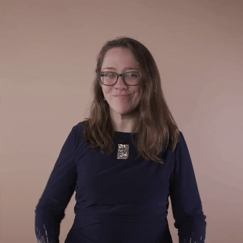 Reaction gif. A Disabled Latina woman with brown wavy hair and glasses smiles broadly and gives you a very deliberate two thumbs up.