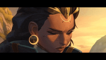 Video game gif. Illari from "Overwatch" looks up with determination as her gold headpiece lights up and her eyes and hair magically change to a white, radiant glow. 
