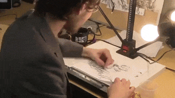 Digital art gif. Alex Boya sketches on paper as we see the drawings take form in the shape of multiple human faces. 