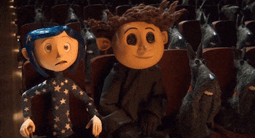 Cartoon gif. Coraline from the movie Coraline sitting in a theater, sitting up and looking scared and startled. Text, "oh my god."