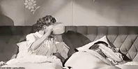 woman pouring water on man GIF