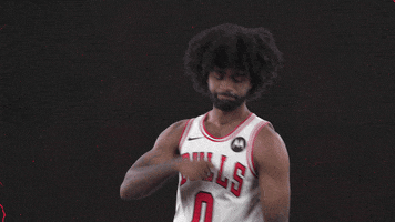 Sports gif. Coby White of the Chicago Bulls wears his jersey as he dances in celebration, rolling his hands and doing the nay nay.
