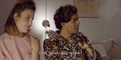 Movie gif. Characters Julie and Patrick of The Souvenir look on in amused confusion as Patrick offers a so-so gesture and asks "How, what, why, when?"