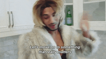 Celebrity gif. Joanne the Scammer disdainfully walks away from a kitchen cabinet, then brushes hair from their eyes. Text, Let's move on to something that really matters.