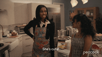 TV gif. In the kitchen, Coco Jones as Hilary in Bel-Air says to Akira Akbar as Ashley, “She’s cute!” Ashley shyly replies, “I know!”