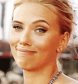 Celebrity gif. Scarlett Johansson smirks while making eye contact with us, raising her eyebrow and smiling as she says "wow."