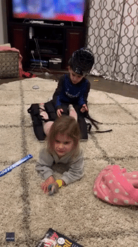 Little Minnesota Girl Entertains Family by Trying on Brother's Clunky Hockey Gear