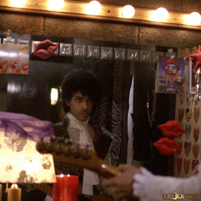 GIF of Prince checking himself out in the mirror