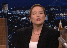 Tonight show gif. Lea Seydoux clasps her hands together and holds them up to her chest. She looks up with pursed lips and closed eyes like she’s begging for a kiss.