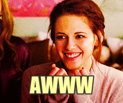Movie gif. Kristen Stewart covers her mouth in a cute surprise. Text, "Awww."