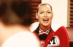 TV gif. Naya Rivera as Santana on Glee watches someone in front of her, appearing speechless with her mouth open and her eyes searching.