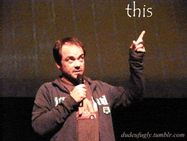 Video gif. A man speaks into a microphone and raises a pointed finger. Text appears around his raised hand, "this, this, this, this."