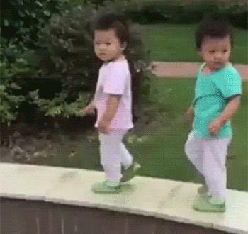 twins fall over GIF