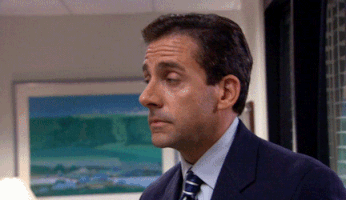 The Office gif. Steve Carell as Michael Scott slowly turns with eyebrows raised and walks into his office.