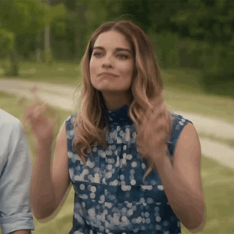 Schitt's Creek gif. Annie Murphy as Alexis crosses her index and middle fingers on both hands in a gesture of good luck.