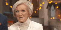 TV gif. Mary Berry on The Great American Baking Show licks her lips and says, “yum.”