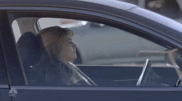 SNL gif. Cecily Strong sits in the driver's seat of a cat and lowers the seat back until it's completely flat. She has a tired, depressed expression on her face.