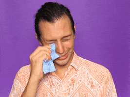 Video gif. A man dramatically dabs away tears as he cries, his shoulders shaking.