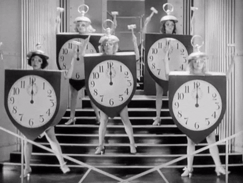 A group of ladies sway left and right in a clock costume.