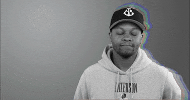 Celebrity gif. Rapper BJ the Chicago Kid shakes his head and covers his face, awkwardly disapproving.