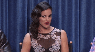 Celebrity gif. Melissa Fumero raises her eyebrows in surprise and says, “Oh.”