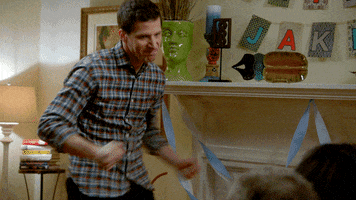 TV gif. Andy Samberg as Jake Peralta on Brooklyn Nine Nine looks down at two people with a big frown and thrusts his hips back and forth, pumping his arms for emphasis.