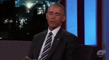 Politics gif. Barack Obama, on a talk show, raises his hand up while looking down humbly with eyes closed while saying thank you.