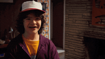 TV gif. Gaten Matarazzo as Dustin Henderson on Stranger Things smiles and says "I love you" as he brings his hands to his mouth and kisses his fingertips.