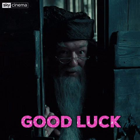 Movie gif. A close-up of Michael Gambon as Albus Dumbledore from Harry Potter peering at us through a wooden door and saying, "Good luck."