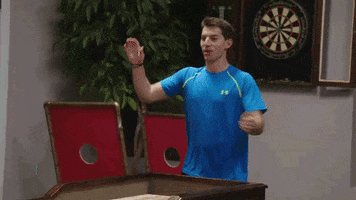 TV gif. Coby Cotton on The Dude Perfect Show claps his hands and then slams his fists down in a smiling yell of triumph.