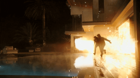 guy walking away from explosion gif