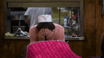 TV gif. Jonathan Kite as Oleg from 2 Broke Girls. He's playing peekaboo with a baby in a stroller. He covers his eyes and opens them while grinning and it makes the baby laugh.